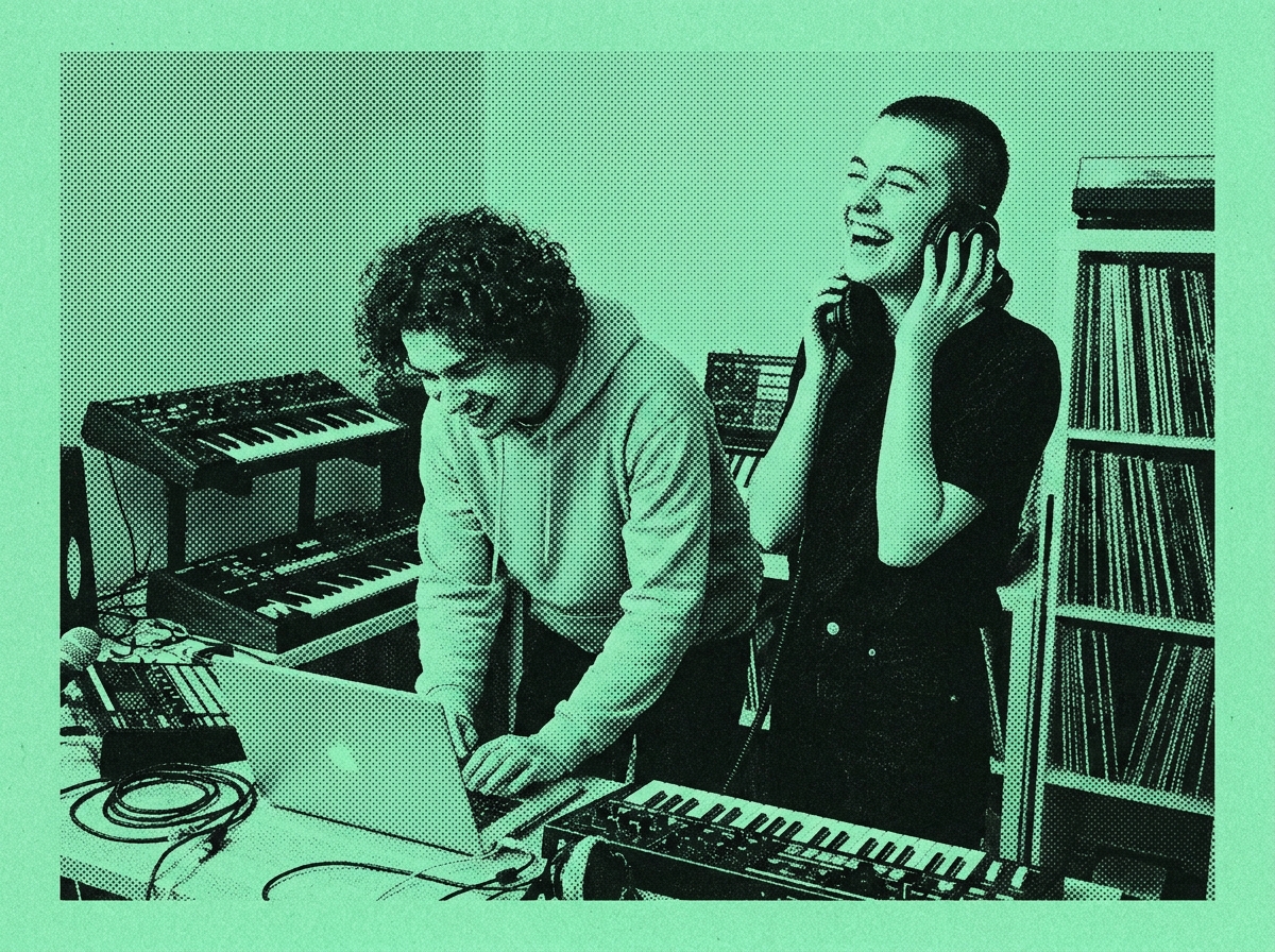 Two producers laughing in a small studio, duotone print